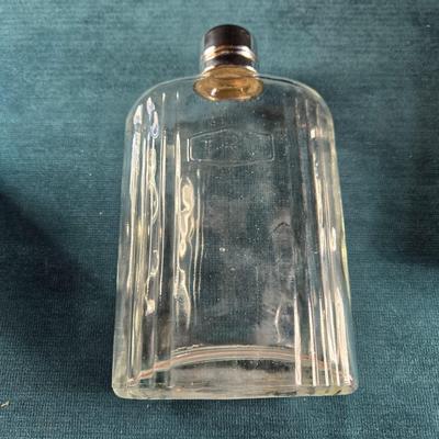 Sale Photo Thumbnail #487: This auction lot is for a Vintage Flask with Faux Leather Case. This is a useful and handsome Flask with Faux Leather Case.  The flask itself is glass and marked TRC.  The case shows wear on the black edging.  Overall in good condition.