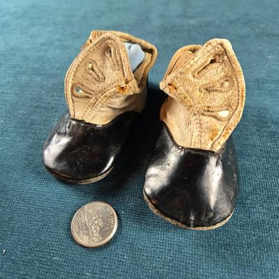 Sale Photo Thumbnail #491: This auction lot is for Victorian Baby Shoes. These are a sweet pair of Victorian Baby Shoes.  The whitish area feels like soft calf's leather and the black area is patent leather.  The soles are suede leather,  They are in very good condition for their a