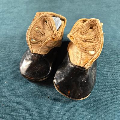 Sale Photo Thumbnail #489: This auction lot is for Victorian Baby Shoes. These are a sweet pair of Victorian Baby Shoes.  The whitish area feels like soft calf's leather and the black area is patent leather.  The soles are suede leather,  They are in very good condition for their a