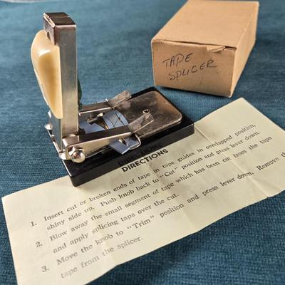 Sale Photo Thumbnail #500: This auction lot is for a Vintage Reel to Reel Audio Tape Splicer. This is a Vintage Reel to Reel Audio Tape Splicer that can still be used.  It is marked made in Japan on its box.  It is used to precisely cut and join magnetic tape - specifically audio. 