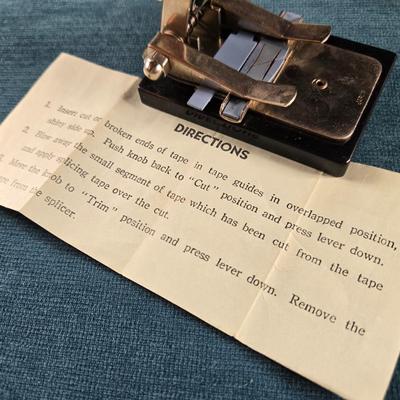 Sale Photo Thumbnail #502: This auction lot is for a Vintage Reel to Reel Audio Tape Splicer. This is a Vintage Reel to Reel Audio Tape Splicer that can still be used.  It is marked made in Japan on its box.  It is used to precisely cut and join magnetic tape - specifically audio. 