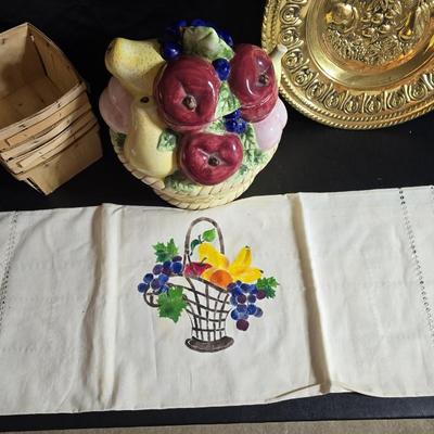 A Fruitful Display - Fruit themed lidded cookie jar - Brass wall plate - Wooden fruit bushel baskets = and a table runner with a fruit...