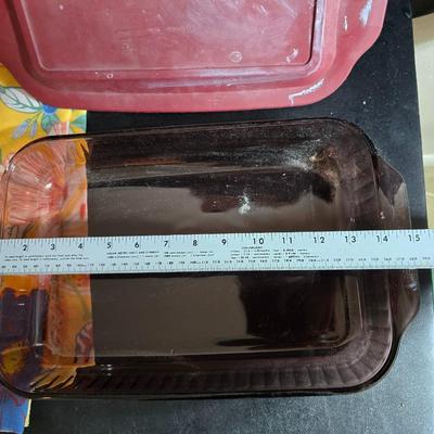 Two 9" x 13" glass Cake pans with Pyrex Portables insulated casserole carrier travel bags a tablecloth and a new flip flop...