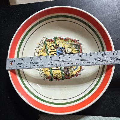 Two large serving bowls a glass cake pan, strainer and 5 square glass containers with cork stoppers