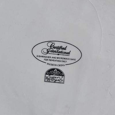 Two large serving bowls a glass cake pan, strainer and 5 square glass containers with cork stoppers