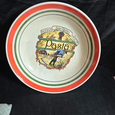 Two large serving bowls a glass cake pan, strainer and 5 square glass containers with cork stoppers