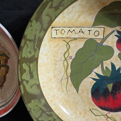 Two large serving bowls a glass cake pan, strainer and 5 square glass containers with cork stoppers