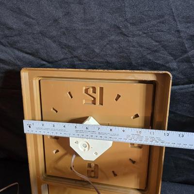 Working 1970s Coca-Cola wall clock with a faux wood grain plastic frame and a commemorative Coca-Cola bottle from the 1984 Summer...
