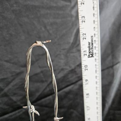 Western themed barbed wire cactus with barbed wire boot and star and a Wilton Armetale pewter cowboy boot pitcher.