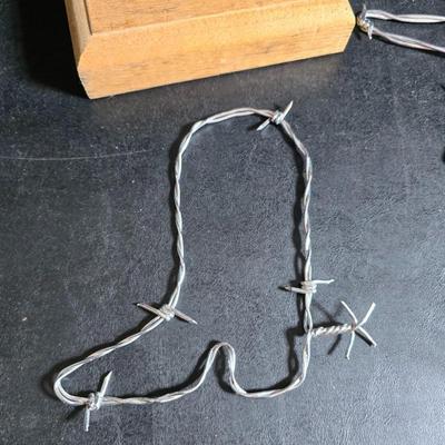 Western themed barbed wire cactus with barbed wire boot and star and a Wilton Armetale pewter cowboy boot pitcher.