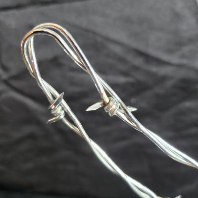 Western themed barbed wire cactus with barbed wire boot and star and a Wilton Armetale pewter cowboy boot pitcher.