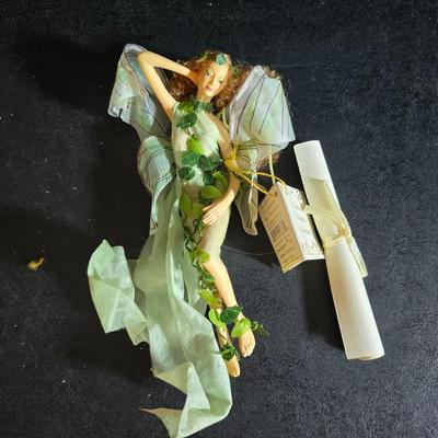 Two metal floral wall buckets with a Fairy, a suncatcher and a thermometer