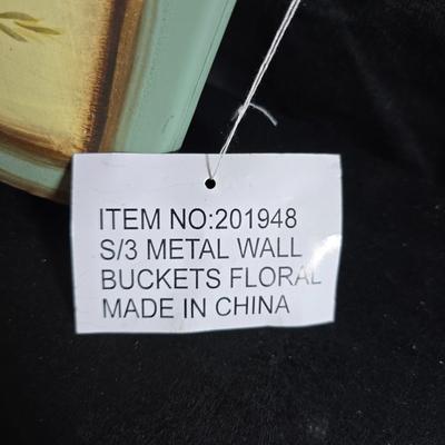 Two metal floral wall buckets with a Fairy, a suncatcher and a thermometer