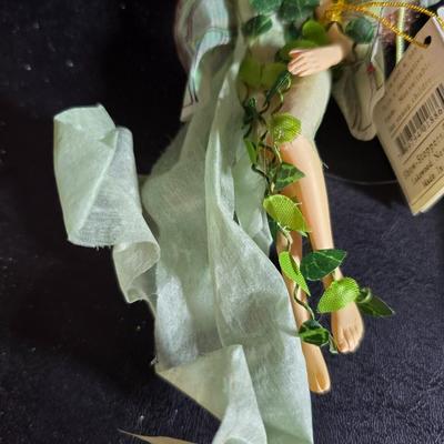 Two metal floral wall buckets with a Fairy, a suncatcher and a thermometer