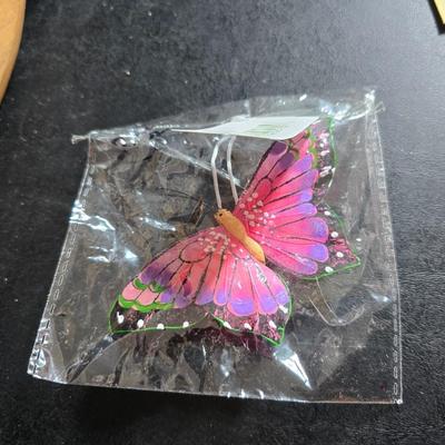 Two matching floral wall buckets, Butterflies, Sun dial clock, a small ceramic garden worm, and a decorative wall hanging