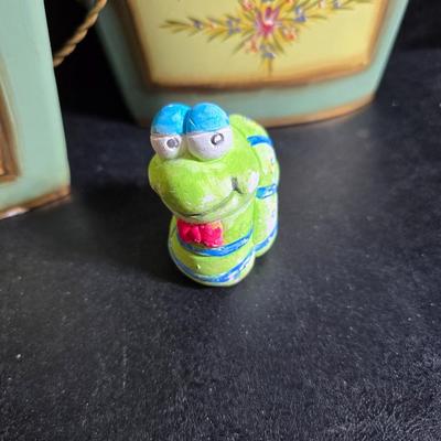 Two matching floral wall buckets, Butterflies, Sun dial clock, a small ceramic garden worm, and a decorative wall hanging