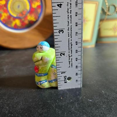 Two matching floral wall buckets, Butterflies, Sun dial clock, a small ceramic garden worm, and a decorative wall hanging