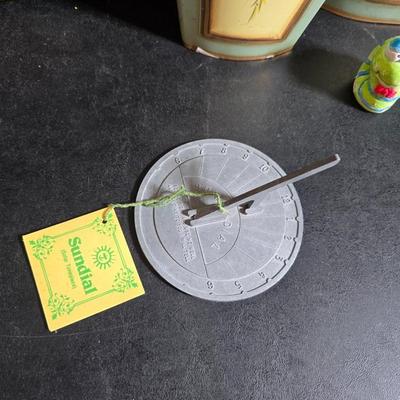 Two matching floral wall buckets, Butterflies, Sun dial clock, a small ceramic garden worm, and a decorative wall hanging