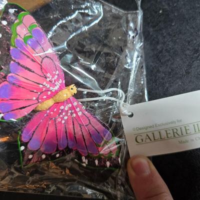 Two matching floral wall buckets, Butterflies, Sun dial clock, a small ceramic garden worm, and a decorative wall hanging