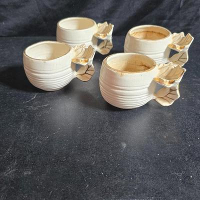 Antique cast metal gold guild clock face frame with Saja China dish - four small, vintage ceramic cups with leaf like handles and a small...