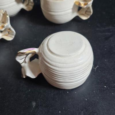 Antique cast metal gold guild clock face frame with Saja China dish - four small, vintage ceramic cups with leaf like handles and a small...