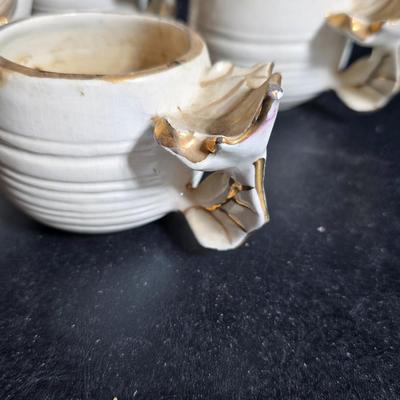 Antique cast metal gold guild clock face frame with Saja China dish - four small, vintage ceramic cups with leaf like handles and a small...