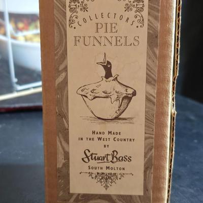 Stuart Bass three-blackbird pie funnel - Wilton 3-tier baking rack - a variety of pie pans and a cookbook