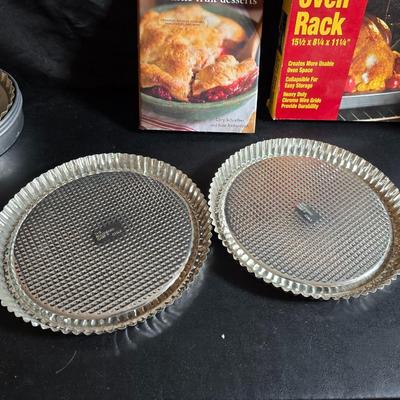 Stuart Bass three-blackbird pie funnel - Wilton 3-tier baking rack - a variety of pie pans and a cookbook