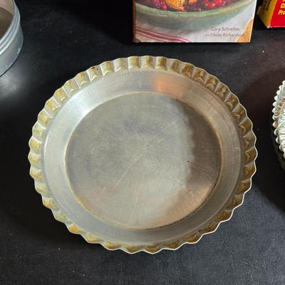 Stuart Bass three-blackbird pie funnel - Wilton 3-tier baking rack - a variety of pie pans and a cookbook