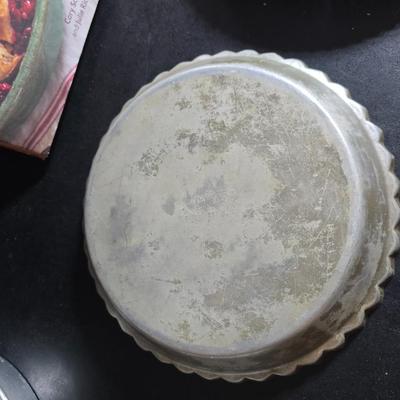 Stuart Bass three-blackbird pie funnel - Wilton 3-tier baking rack - a variety of pie pans and a cookbook