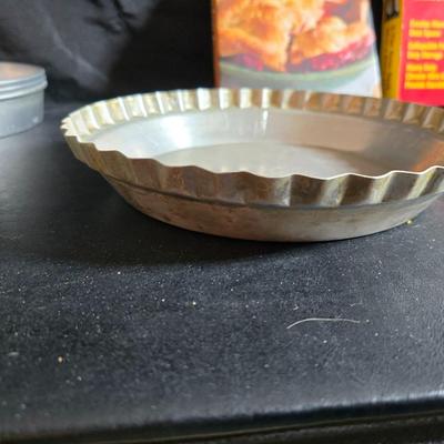 Stuart Bass three-blackbird pie funnel - Wilton 3-tier baking rack - a variety of pie pans and a cookbook