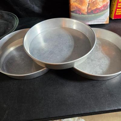 Stuart Bass three-blackbird pie funnel - Wilton 3-tier baking rack - a variety of pie pans and a cookbook