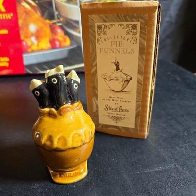 Stuart Bass three-blackbird pie funnel - Wilton 3-tier baking rack - a variety of pie pans and a cookbook