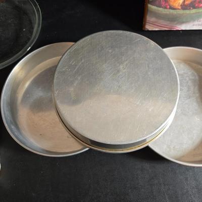 Stuart Bass three-blackbird pie funnel - Wilton 3-tier baking rack - a variety of pie pans and a cookbook