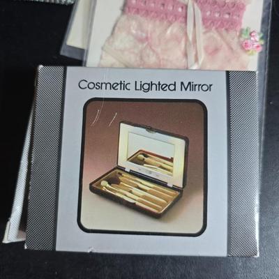 Dress shaped hanging organizer - Mirror - Nail care kit - Mini shaver - small trinket boxes - soap dispenser - and other hygiene makeup...