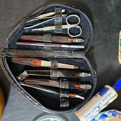 Dress shaped hanging organizer - Mirror - Nail care kit - Mini shaver - small trinket boxes - soap dispenser - and other hygiene makeup...