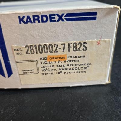 File box with new packages of folders and a nice wall clock