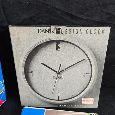 File box with new packages of folders and a nice wall clock