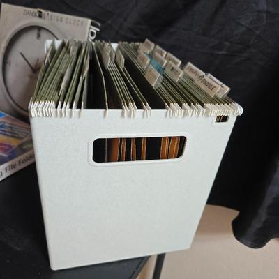 File box with new packages of folders and a nice wall clock