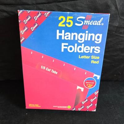 File box with new packages of folders and a nice wall clock