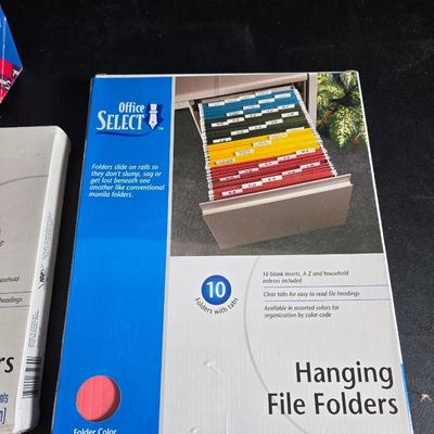 File box with new packages of folders and a nice wall clock