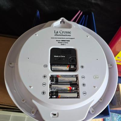 Home office or school supplies - binders - wall clock - clipboard - and an assortment of other office / school supplies.