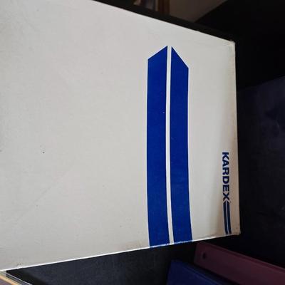 Home office or school supplies - binders - wall clock - clipboard - and an assortment of other office / school supplies.