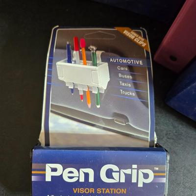 Home office or school supplies - binders - wall clock - clipboard - and an assortment of other office / school supplies.