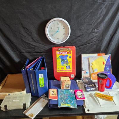 Home office or school supplies - binders - wall clock - clipboard - and an assortment of other office / school supplies.