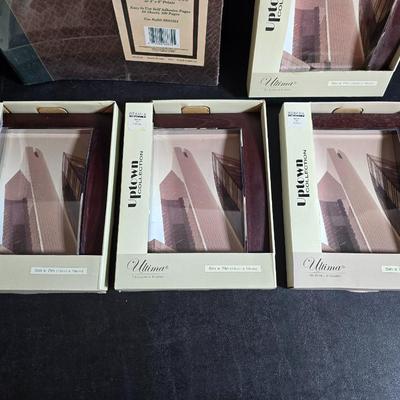 Four brand new matching picture frames with magnetic photo album and two candle holders