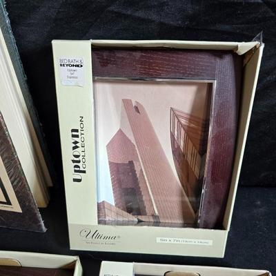 Four brand new matching picture frames with magnetic photo album and two candle holders