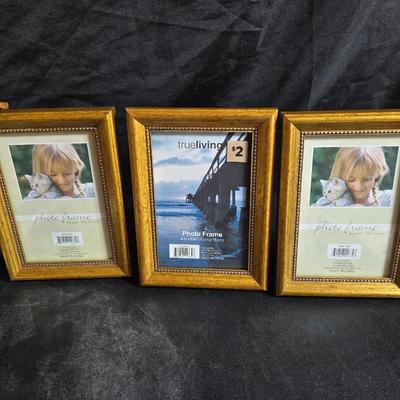 A variety of picture frames and a magnetic photo album