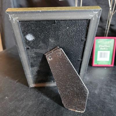 A variety of picture frames and a magnetic photo album