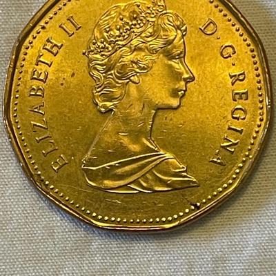 1955 EASTERN CARIBBEAN STATES 50 CENT COIN. 1988 CANADIAN “LOONIE” ONE DOLLAR COIN